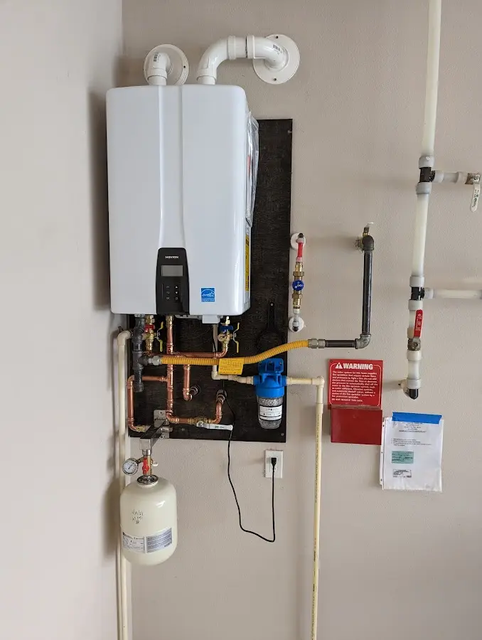 Professional plumber installing copper piping in a Liberty Hill home